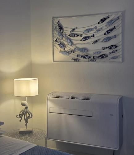 a white refrigerator in a room with a lamp at Camera con Vista in Termoli