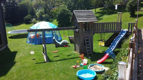 a playground with a play set and a slide at Ferienwohnung Hobelleitner in Sankt Blasen