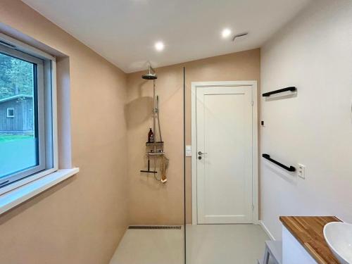 PiggabodaにあるModern Peninsula Cabin With Panoramic Viewのシャワーと洗面台付きのバスルーム