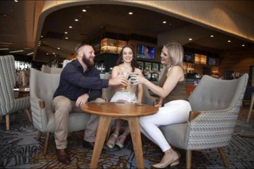 a group of people sitting around a table in a bar at Luxary Home Marriot Marquis in Baku