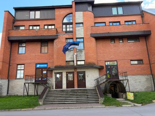 a red brick building with a staircase in front of it at Narva Kangelaste 2 Apartments in Narva