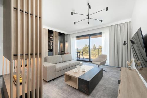 a living room with a couch and a table at Shellter Hotel Resort & Spa in Rogowo