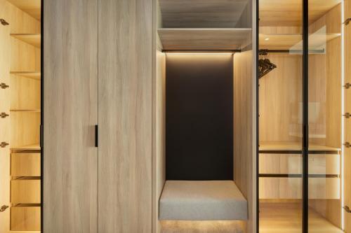 a walk in closet with a glass door at Shellter Hotel Resort & Spa in Rogowo