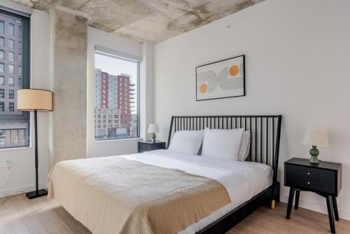 a bedroom with a large bed and two windows at Blueground Crystal City rooftop pool nr Potomac WDC-1031 in Addison Heights
