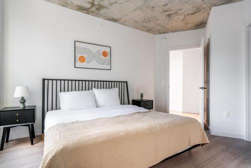 a white bedroom with a large bed with white pillows at Blueground Crystal City rooftop pool nr Potomac WDC-1031 in Addison Heights