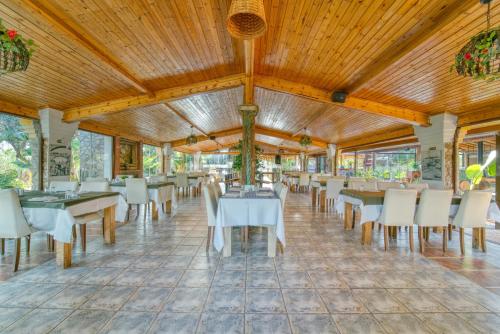 a dining room with white tables and chairs at Osman Aga Culture House in Mağusa