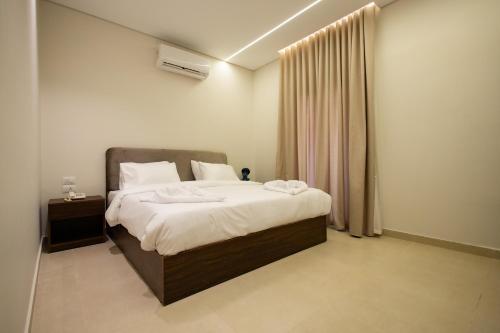a bedroom with a bed with two towels on it at Imperial Luxury Hotel in Cairo