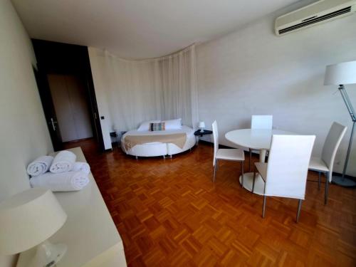 a hotel room with a bed and a table and chairs at Lugano Luxury Parco by Quokka 360 - Central Apartment with Terrace in Lugano