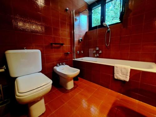 a bathroom with a toilet and a tub and a sink at Lugano Luxury Parco by Quokka 360 - Central Apartment with Terrace in Lugano