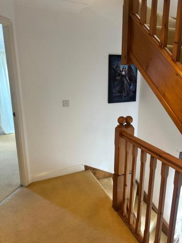 a staircase in a house with a picture on the wall at Fabrizio Residence 2 in Ifield