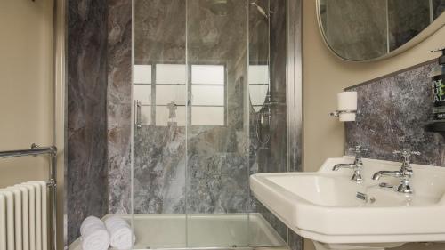 a bathroom with a sink and a tub and a shower at Paradise Penthouse in Downham Market