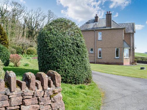 a large bush in front of a house at Woodend Farmhouse Halmyre in Haugh of Urr