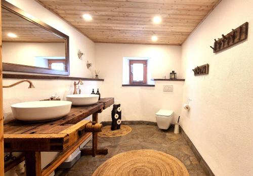 a bathroom with two sinks and a toilet at Almliesl KREM-753 in Eisentratten