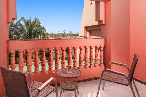 a table and chairs on a balcony with a fence at Pickalbatros Aqua Fun Club All Inclusive in Marrakech