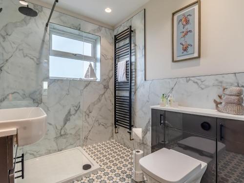 a bathroom with a sink and a toilet and a tub at The Farm House in Elston