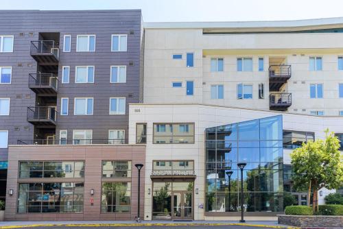 an apartment building with a glass fronted building at Blueground Mountain View pool nr Shoreline Park SFO-1927 in Castro City