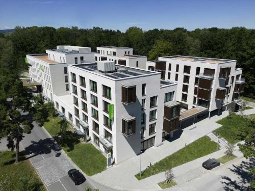 an aerial view of a large white building at ibis Styles Friedrichshafen in Friedrichshafen