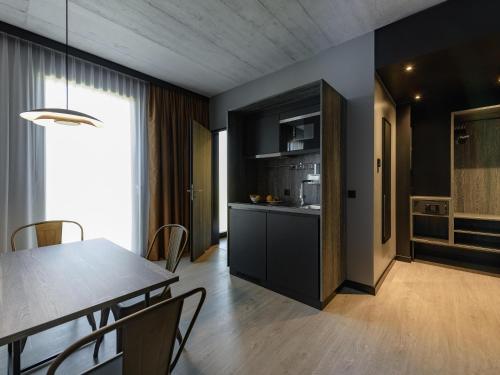 a kitchen and dining room with a table and chairs at ibis Styles Friedrichshafen in Friedrichshafen