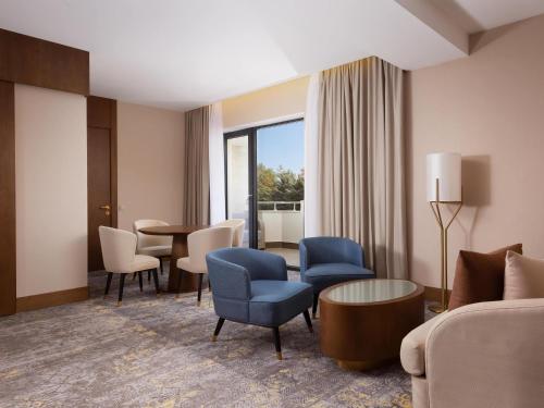 a living room with a couch and chairs and a table at Swissôtel Wellness Resort Alatau Almaty in Almaty