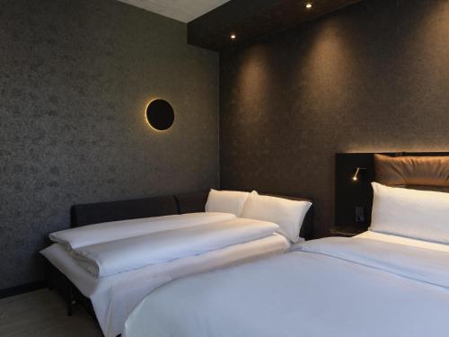 two beds sitting next to each other in a room at ibis Styles Friedrichshafen in Friedrichshafen