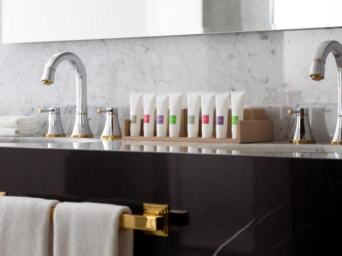 a kitchen counter with a sink and a counter top with towels at Swissôtel Wellness Resort Alatau Almaty in Almaty