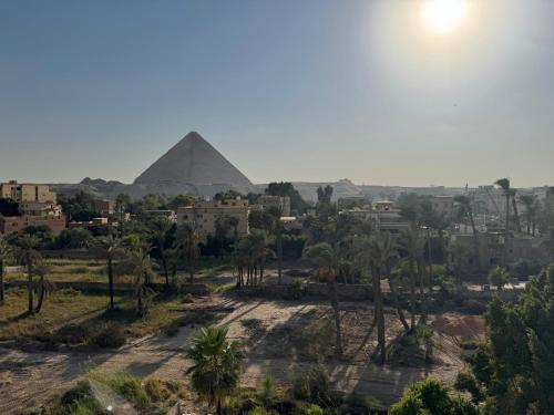 a view of the pyramids of giza from the city at Palacio Pyramids Hotel in Cairo