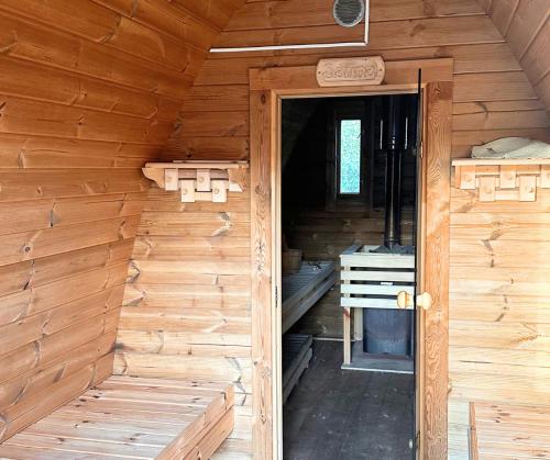 an inside view of a wooden cabin with an open door at KOPUVA in Nidden