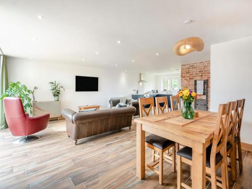Una sala de estar con una mesa de comedor y un sofá. en Heron's Den - Uk44529, en Horncastle