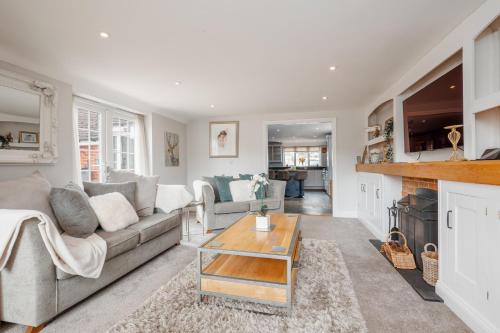 a living room with a couch and a table at Forest Edge by Grandeur Property in Alderholt