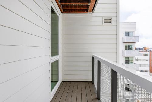 a balcony with white siding and a window at Blueground Downtown Berkeley rooftop nr UC Berkeley SFO-1954 in Berkeley
