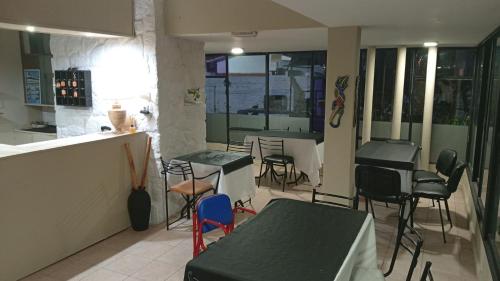 a restaurant with chairs and tables and a counter at Hotel inti huasi in Villa Carlos Paz