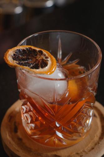 a drink in a glass with an orange slice on top at Hôtel La Bourdonnais by Inwood Hotels in Paris