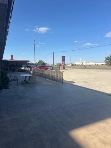 a patio with a picnic table and a fence at Hotel Poem in Călăraşi