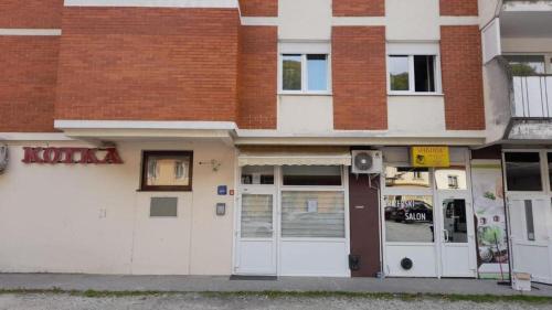 a building with white doors and red brick at Apartment Vanja in Krapina