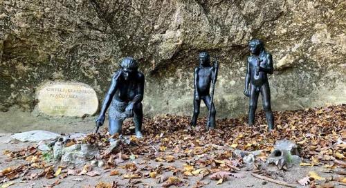 three statues of people standing on a pile of leaves at Apartment Vanja in Krapina