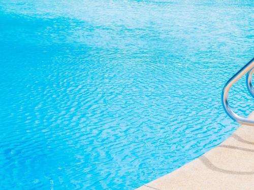 a pool of blue water with a metal object in it at Mercure Newcastle in Newcastle