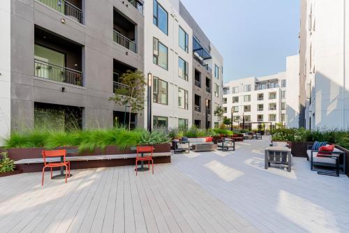 a courtyard with chairs and tables in a building at Blueground Ingold - Milldale pool nr Park SFO-1969 in Millbrae