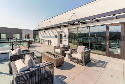 a patio with chairs and tables on a building at Blueground Ingold - Milldale pool nr Park SFO-1969 in Millbrae