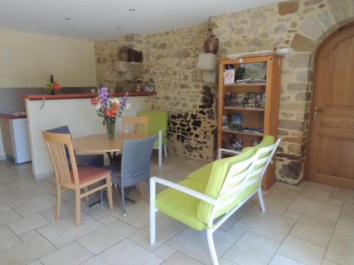 a kitchen and dining room with a table and chairs at Les Stiers in Chancé