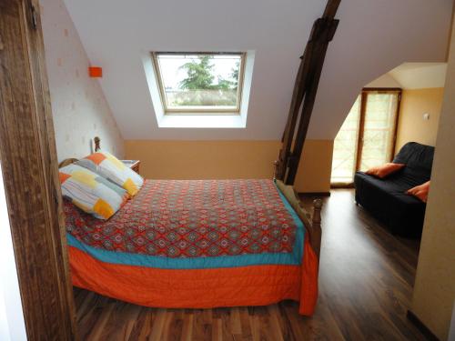 a bedroom with a bed and a window and a couch at Les Stiers in Chancé