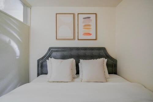 a bedroom with a white bed with two pillows at Blueground Brighton fitness center nr Park SEA-876 in Seattle