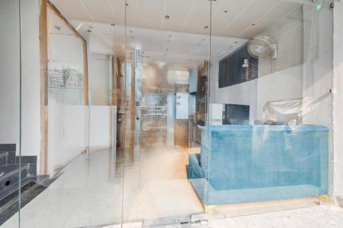 a glass wall in a room with a hallway at Collection O Bairhana Road Prayagraj in Prayagraj