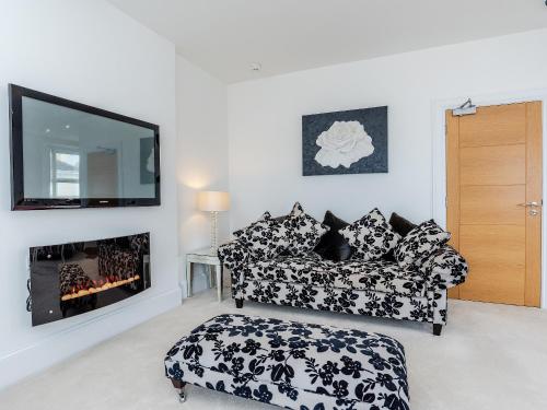 a living room with a couch and a fireplace at Babbacombe Bay, Torquay in Torquay