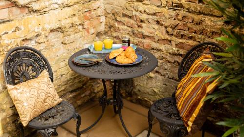 a black table with a plate of food on it at Paradise Penthouse in Downham Market