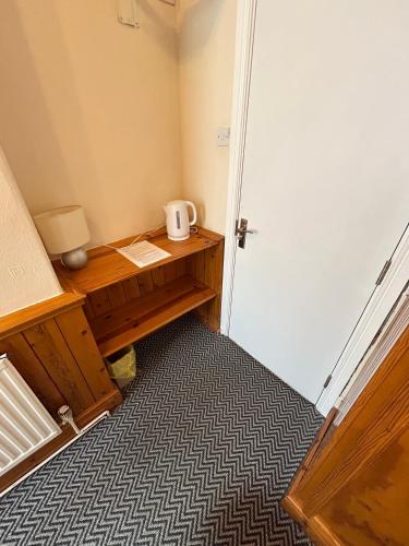 a room with a wooden desk and a door at The Egerton Arms Hotel Salford in Manchester