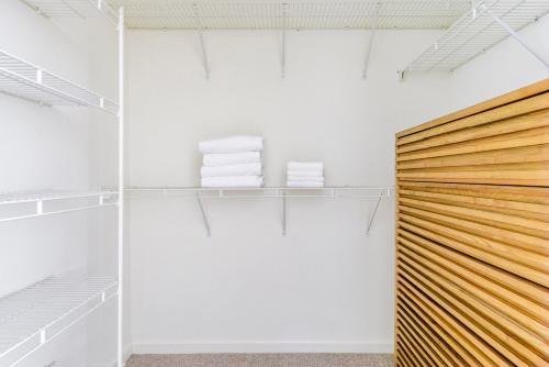 a closet with white walls and a wooden door at Blueground Diridon pool nr San Jose Park SFO-1972 in San Jose