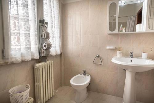 une salle de bain blanche avec un lavabo et des toilettes dans l'établissement Appartamento Pennazzi, à Santa Maria degli Angeli