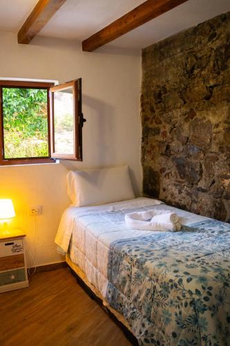 a bedroom with a bed with a dog laying on it at VV Casa Bibiana "by henrypole home" in Hermigua