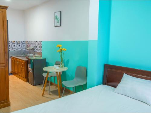 a bedroom with a bed and a table with a table at BOO Hostel , By the Beach in Da Nang