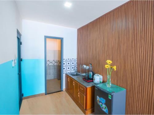 a bathroom with a vase of flowers on a counter at BOO Hostel , By the Beach in Da Nang
